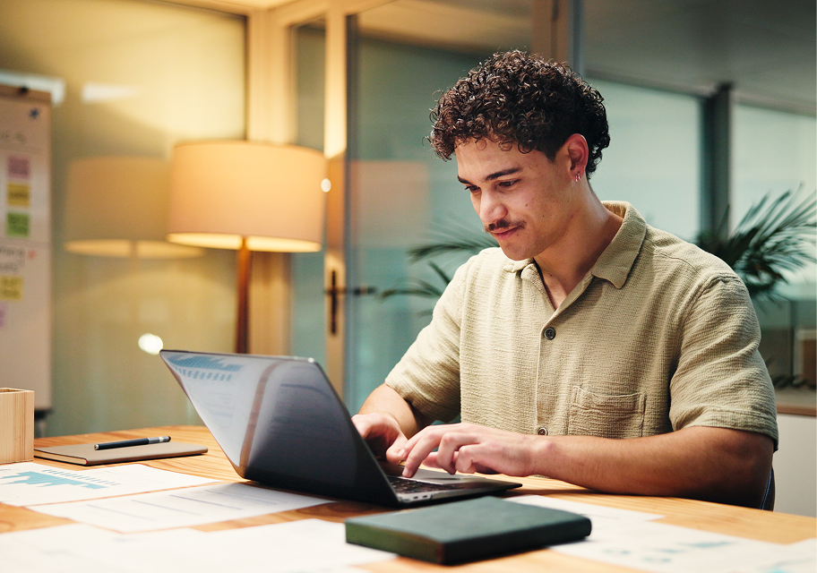 Young person reviewing work on a laptop